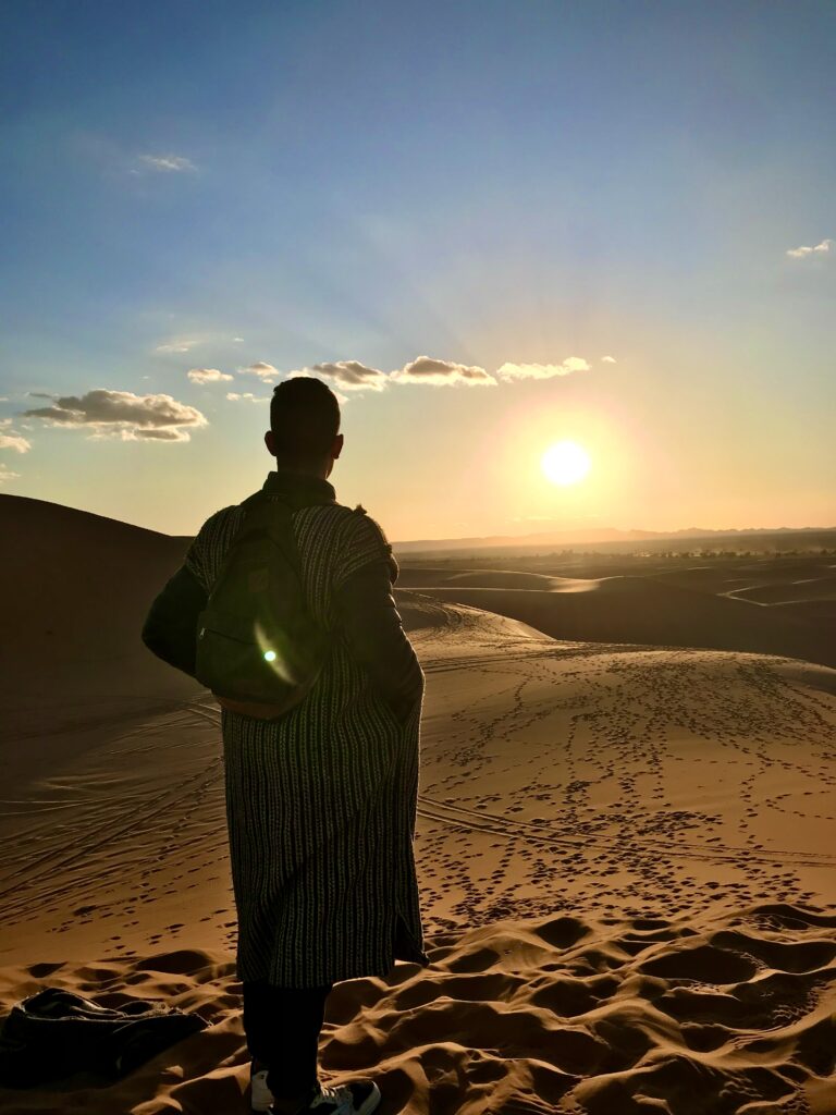 Nabil ait chaib, a desert man in the dunes of the sahara desert of morocco